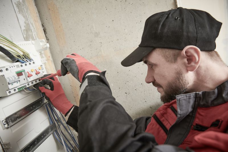 Electrician Working on a Circuit Breaker